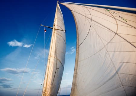 White sails of the yacht against blue sky. Baltic sea, Latvia