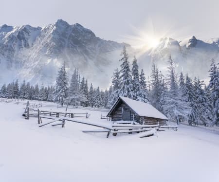 Old farm in the mountains. Foggy winter morning.