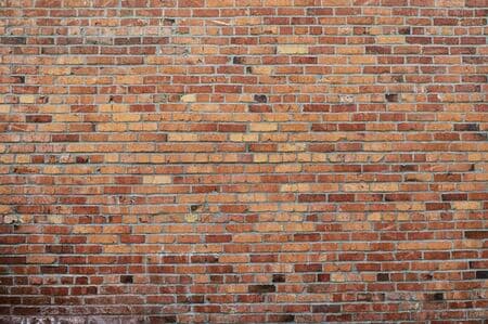 Old red brick wall background texture close up