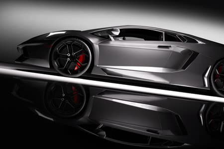 Grey fast sports car in spotlight, black background. Shiny, new, luxurious. 3D rendering